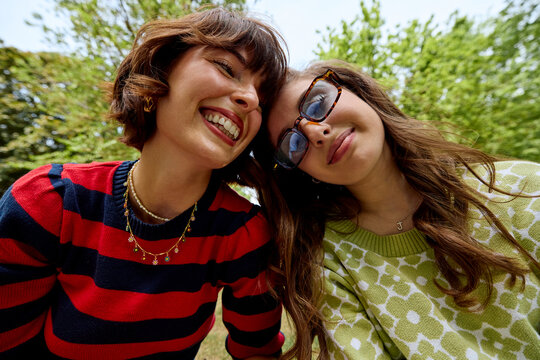 Mother and daughter share smiles outdoors