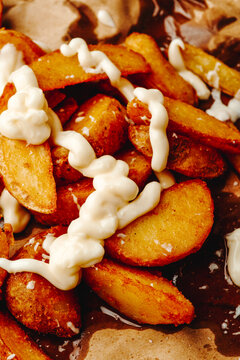 mayonnaise covers crispy potato wedges