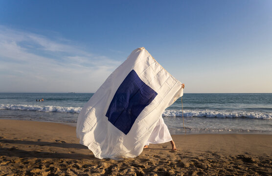 Navigation flag held by a woman on beach