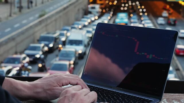 Asian businessman using laptop computer in the park, man working outdoor near modern office. Park street airport terminal.