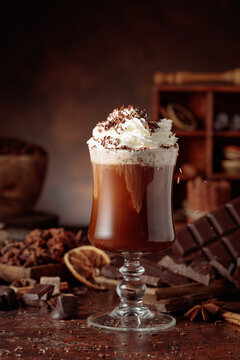 Hot chocolate topped with whipped cream and sprinkled with chocolate chips.