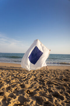 Signal flag held by a woman on beach
