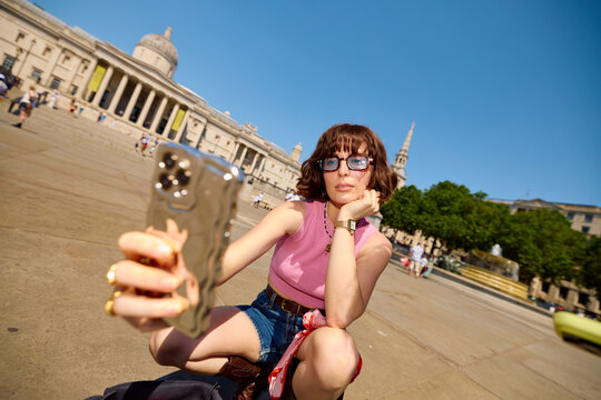 Woman Takes Selfie in City Square in London