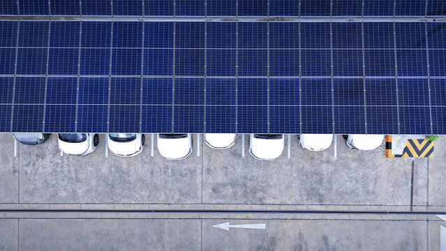 Solar roof. Aerial drone view of solar roof of carport or carpark. Photovoltaic panels covering a parking lot. Clean renewable energy infrastructure supports sustainable transportation. Solar energy