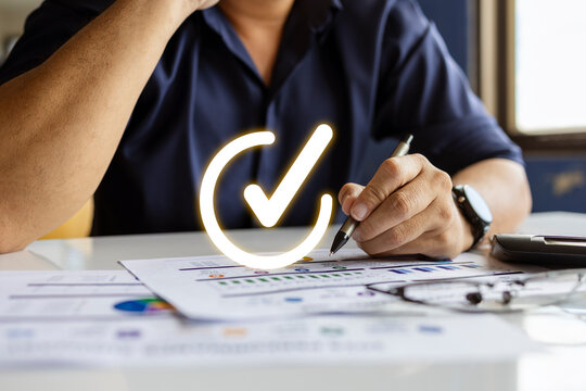 Businessman Reviewing Financial Report with Approval Check Mark for Business Success