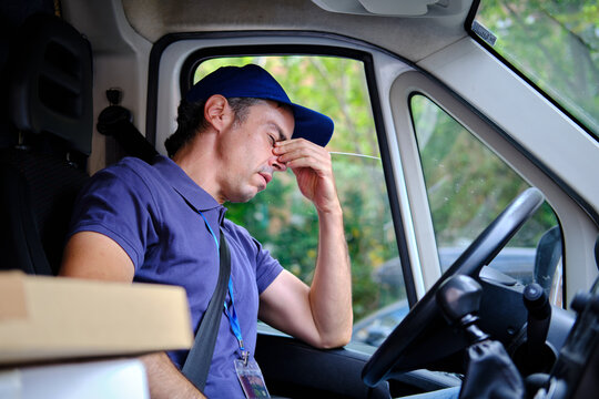 Delivery man experiencing stress and burnout driving van