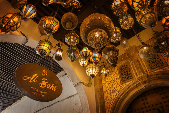 Various traditional moroccan lamps on the ceiling at the entrance of moroccan riyad house in Rabat