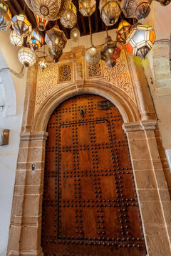 Various traditional moroccan lamps on the ceiling at the entrance of moroccan riyad house in Rabat
