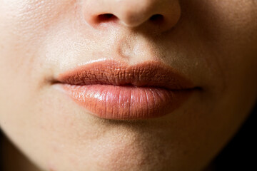 Fototapeta premium Warm Terracotta Lipstick: Luxury Cosmetics Close-Up with Satin Finish and Subtle Ombre Gradient