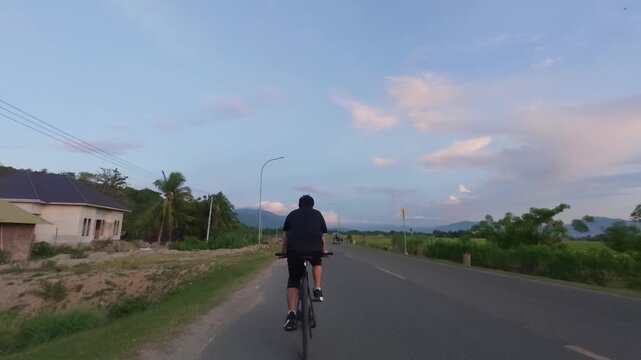 Cyclist on Rural Road at Dusk