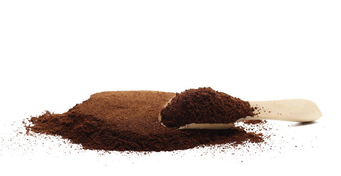 Milled coffee powder pile for espresso in wooden spoon isolated on white background, side view