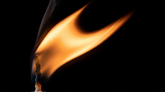 Single Candle Glowing Softly in Darkness
