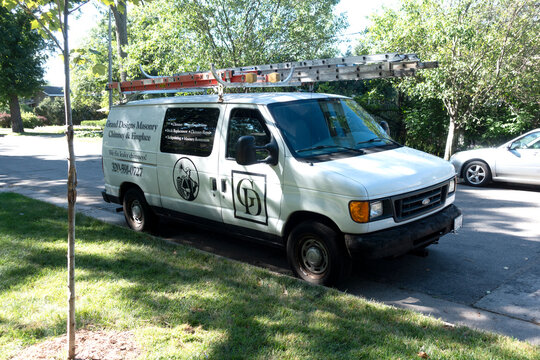 Truck making a house call for repairing or installing fireplaces and chimneys with ladders on the roof. St Paul Minnesota MN USA