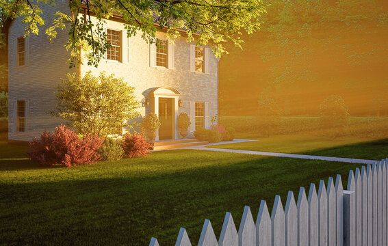 Classic Two-Story House with White Fence at Golden Sunset