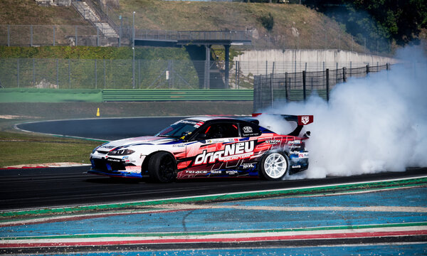 Drift car action, drifting on racetrack with large amount of smoke