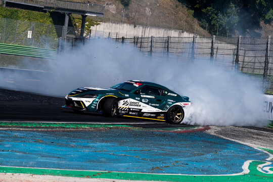 Drift car action, drifting on racetrack with large amount of smoke