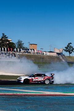 Drift car action, drifting on racetrack with large amount of smoke