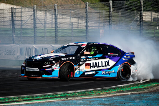 Drift car action, drifting on racetrack with large amount of smoke