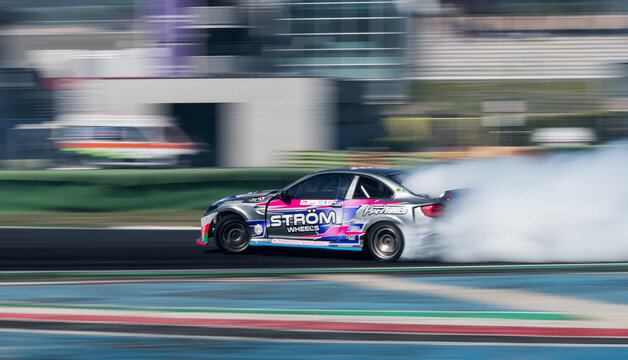 Drift car action, drifting on racetrack with large amount of smoke, blurred motion background