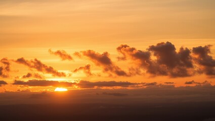 Fototapeta premium Beautiful orange sunset sky with clouds and bright sun