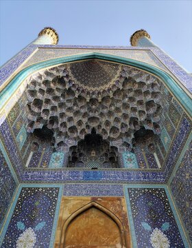 Historic Iranian Mosque Entrance with Intricate Muqarnas Ceiling