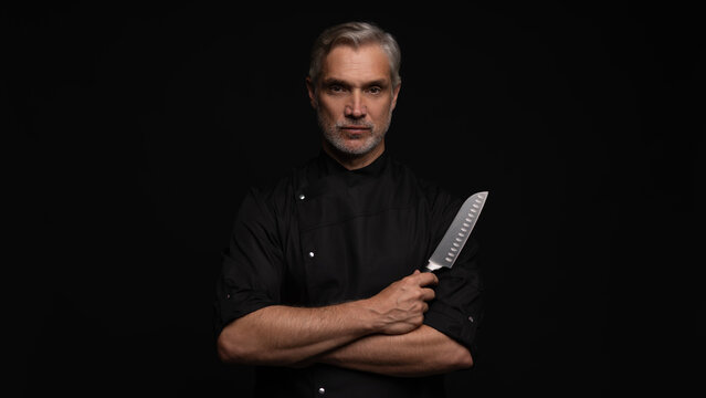 Portrait of positive 50s mature chef cook, black outfit