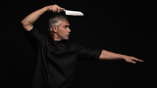 Portrait of positive 50s mature chef cook, black outfit