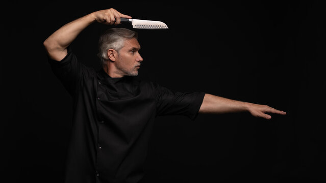 Portrait of positive 50s mature chef cook, black outfit