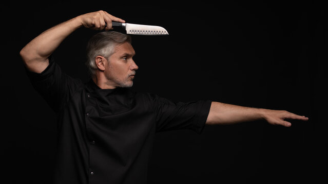 Portrait of positive 50s mature chef cook, black outfit
