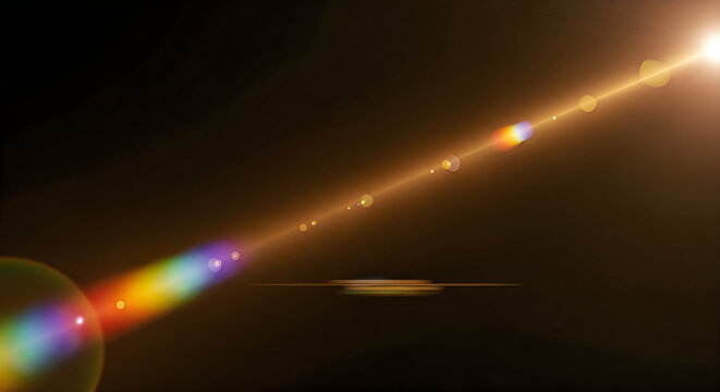 Dramatic lens flare effect with rainbow spectrum and golden light streaks on a dark background