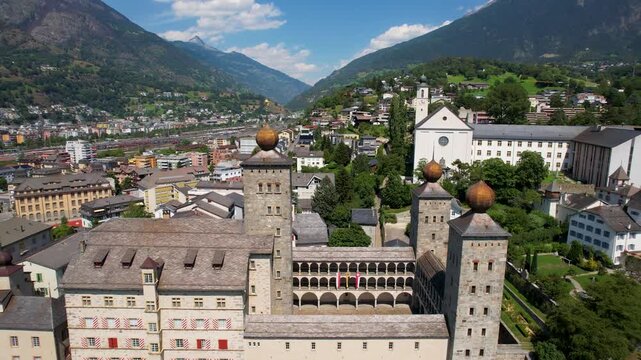 Stockalper Castle Baroque Dome Towers Brig Switzerland. Cinematic Close-up to Wide Drone Reveal of Historic Palace Architecture and Cityscape Panoramic Alpine Mountain Backdrop Summer 4K Footage