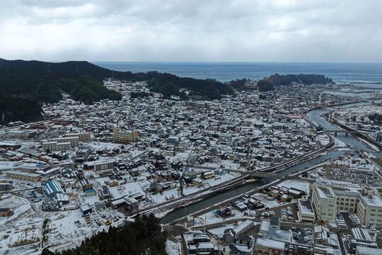 Aerial drone photo of snow-covered coastal town in Wajima, Ishikawa, Japan