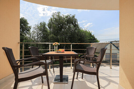 Outdoor balcony with table and chairs