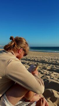 Man reading book on Baleal beach overlooking Atlantic Ocean

Relaxed traveler reading a book beside the Atlantic Ocean on Baleal Beach in Portugal. 