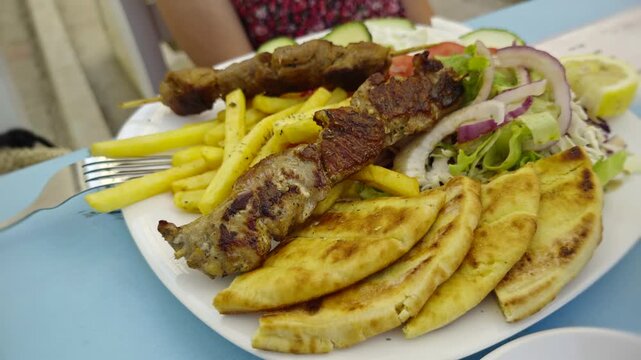 Greek Souvlaki With Grilled Pork Skewers Pita Bread French Fries And Fresh Salad. Mediterranean Food