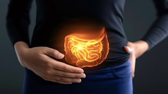 Person holding abdomen, indicating discomfort or pain, with glowing intestines symbolizing gastrointestinal issues, inflammation, or problems related to gut health and digestion