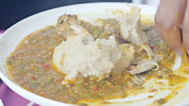 Traditional West African eba swallow and okra soup plate