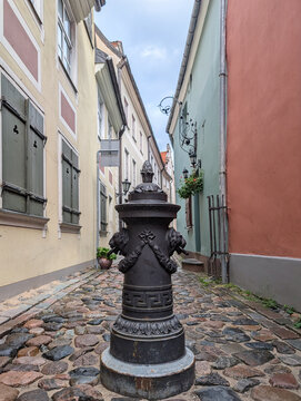Historical cast iron water hydrant with lions on medieval Troksnu Street in Old Town Riga