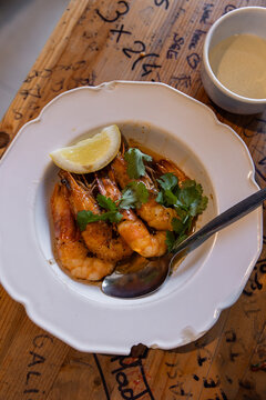 High angle view of plate of fresh-caught shrimp prepared with lemon and parsley in Lisbon, Portugal 