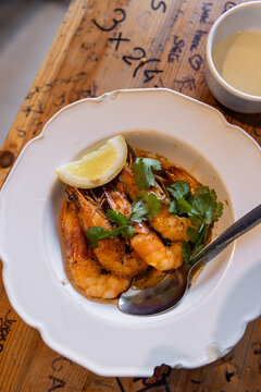 High angle view of plate of fresh-caught shrimp prepared with lemon and parsley in Lisbon, Portugal 
