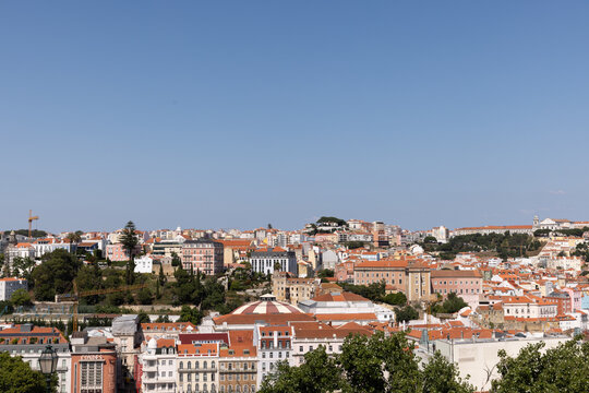 view of Lisbon city with architecture with Tagus River in the background, blue sky, sunny day
