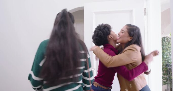 Hostess and female friends arriving, greeting, opening door, hugging, entering foyer, closing door