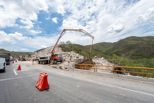 Truck mounted concrete pump Putzmeister BSF 36-4, by Putzmeister Holding, pouring concrete for dikes during a road expansion construction project in Manzanillo, Colima, Mexico, July 20 2026.