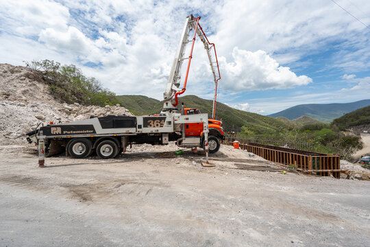 Truck mounted concrete pump Putzmeister BSF 36-4, by Putzmeister Holding, pouring concrete for dikes during a road expansion construction project in Manzanillo, Colima, Mexico, July 20 2026.