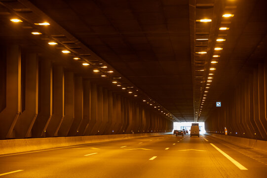 View of a French and European autoroute tunnel, showing lanes, traffic and motorway infrastructure, road signes