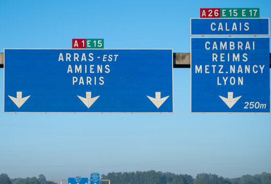 View of a French and European autoroute with overhead directional signs pointing to major cities like Paris, Bordeaux, Lille, Calais, showing lanes, traffic and motorway infrastructure, road signes
