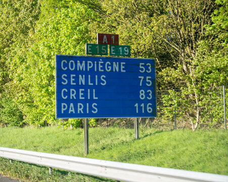 View of a French and European autoroute with overhead directional signs pointing to major cities like Paris, Bordeaux, Lille, Calais, showing lanes, traffic and motorway infrastructure, road signes