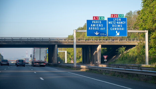 View of a French and European autoroute with overhead directional signs pointing to major cities like Paris, Bordeaux, Lille, Calais, showing lanes, traffic and motorway infrastructure, road signes