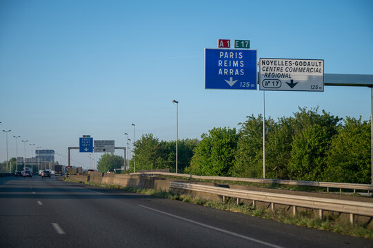 View of a French and European autoroute with overhead directional signs pointing to major cities like Paris, Bordeaux, Lille, Calais, showing lanes, traffic and motorway infrastructure, road signes