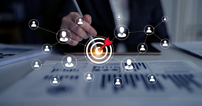 Professional business concept showing focused target and collaboration in a modern office. Highlights importance of teamwork and strategic planning for achieving goals. Ledger